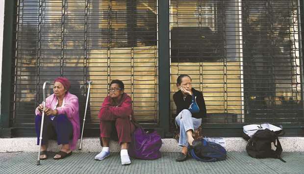 Patients on dialysis treatment wait outside a closed clinic during a power outage in Caracas yesterday.