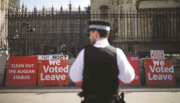Pro-Brexit placards are pictured outside the Houses of Parliament in London yesterday.