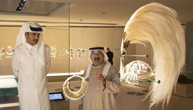 His Highness the Amir Sheikh Tamim bin Hamad al-Thani and Kuwait's First Deputy Prime Minister and Defence Minister Sheikh Nasser Sabah al-Ahmad al-Sabah look at one of the exhibits at the new museum.