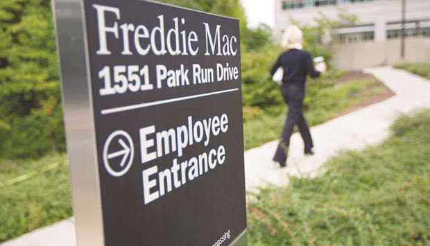 A woman walks towards a Freddie Mac office building in McLean, Virginia (file). A widely anticipated presidential memorandum, released by the White House on Wednesday calls on the Treasury Department to write a proposal for ending federal conservatorship of Fannie and Freddie and increasing competition for the companies.