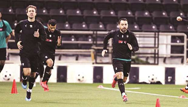 Al Sadd's Xavi Hernandez (right) and Gabi Fernandez train ahead of their QNB Stars League match against Al Duhail.
