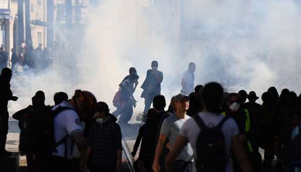 Protesters are seen among tear gas smoke during clashes with police at a demonstration as part of a 20th consecutive Saturday of protests called by the ,yellow vests, (gilets jaunes) movement in Avignon, southeastern France
