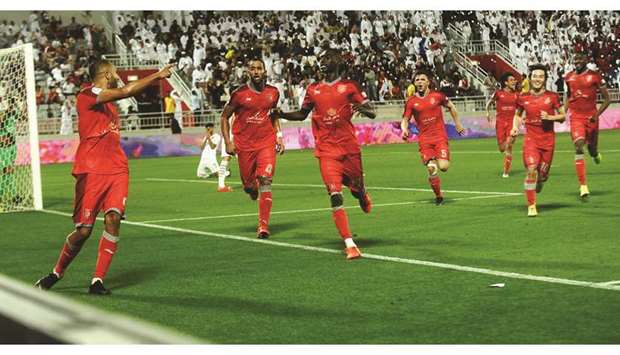 Al Duhailu2019s Yousef El Arabi (left) celebrates his goal with teammates during their QNB Stars League match at Abdullah Bin Khalifa Stadium yesterday. PICTURES: Shemeer Rasheed, Anas Khalid