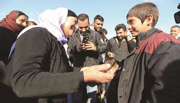 A Yazidi survivor boy is greeted by his relative following his release from Islamic State militants in Syria, in Duhok, Iraq, yesterday.