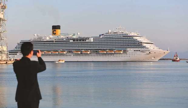 A Chinese observer takes a picture of the Costa Venezia cruise ship leaving the port of the Italian company Fincantieri shipyard in Monfalcone on Thursday.
