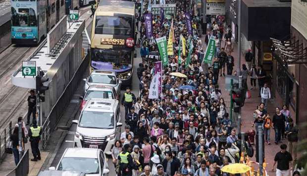 Protesters march along a street during a rally in Hong Kong to protest against the government's plans to approve extraditions with mainland China, Taiwan and Macau.