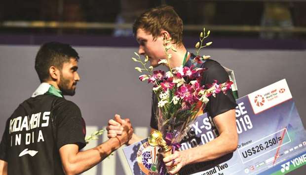 Winner Viktor Axelsen (right) of Denmark shakes hands with runner-up Kidambi Srikanth of India after the India Open badminton final in New Delhi yesterday. (AFP)