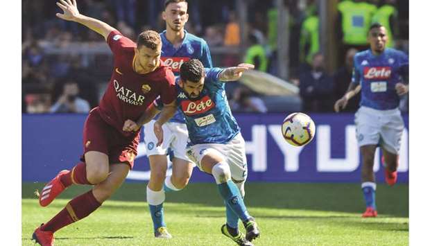 Romau2019s forward Edin Dzeko (left) and Napoliu2019s defender Elseid Hysaj vie for the ball during the Italian Serie A match in Rome yesterday. (AFP)