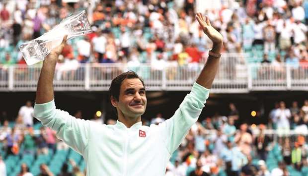 Roger Federer of Switzerland poses with the winneru2019s trophy after defeating John Isner (not pictured) in Miami Open final in Miami Gardens, Florida, yesterday. (AFP)