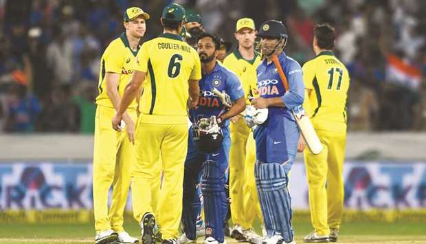 Australian players congratulate Indiau2019s Kedar Jadhav (centre) and Mahendra Singh Dhoni (second from right) after Indiau2019s win in the first ODI in Hyderabad yesterday. (AFP)