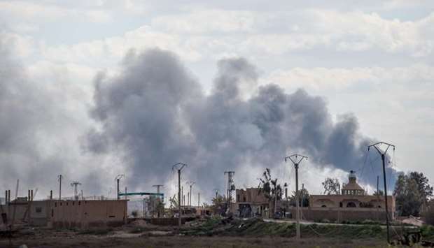 Smoke billows after shelling on the Islamic State (IS) group's last holdout of Baghouz, in the eastern Syrian Deir Ezzor province yesterday.
