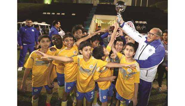Gharafa players celebrate after winning Aspire Football League U-12 title.
