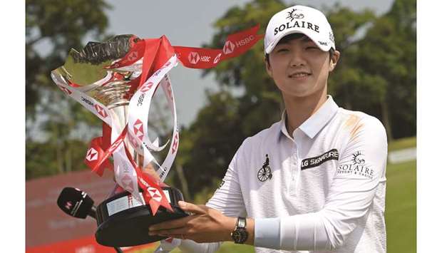 Park Sung-hyun of South Korea poses with the winneru2019s trophy after the final round of the HSBC Womenu2019s World Championship in Singapore yesterday. (AFP)