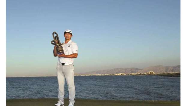 Kurt Kitayama poses with the Oman Open trophy in Muscat yesterday.