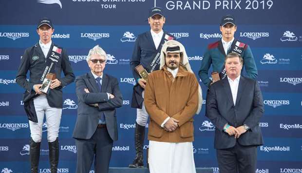 Qatar Olympic Committee president HE Sheikh Joaan bin Hamad al-Thani poses with the Grand Prix winner Julien Epaillard (rear, centre) of France, second-placed Ben Maher (left) of Britain and third-placed Nicola Philippaerts (rear, right) of Belgium in the Longines Global Champions Tour at Al Shaqab arena yesterday.