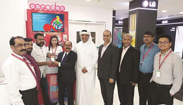 Jumbo and Ooredoo officials mark the occasion.