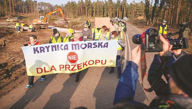 People protest against the digging of a canal on Vistula Spit near Skowronki last month. The banner reads, u2018Krynica Morskau2019 (No to the tunnel).