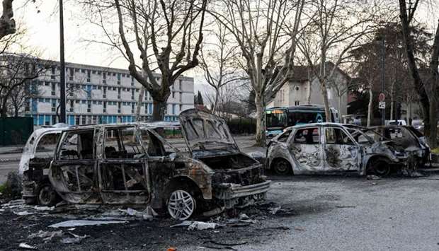 Burnt cars in the street where riots sparked last night, for the third night in a row, following the death of 2 young people on a scooter as they were chased by the police on March 2, in Grenoble central-eastern France