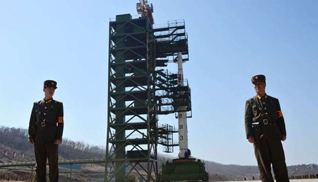 File photo shows two North Korean soldiers standing guard in front of the Unha-3 rocket at at the Sohae Satellite Launch Station in Tongchang-Ri