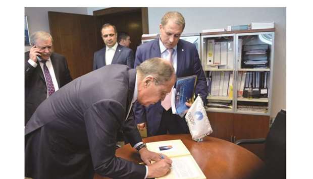 Lavrov signs on the dignitaries visit book at the Gas Exporting Countries Forum (GECF) Secretariat in Doha yesterday as Dr Sentyurin looks on.