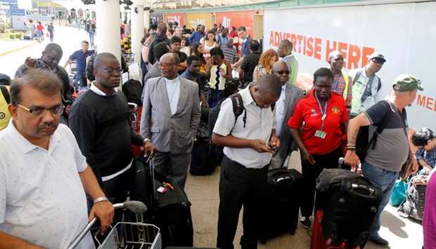 Passengers gather to be screened for check-in at Jomo Kenyatta International Airport during a labour dispute that grounded flights, on the outskirts of Nairobi