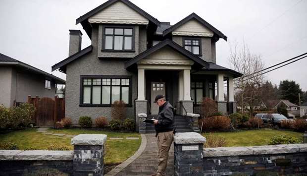 A member of a private security firm stands outside of the family home of Huawei's financial chief Meng Wanzhou, in Vancouver, British Columbia, Canada, January 26, 2019