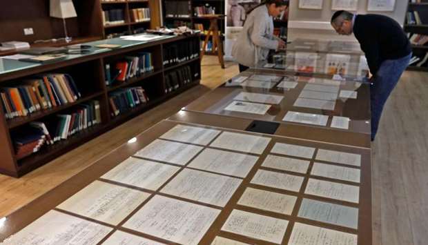 Visitors look at some of Albert Einsteinu2019s manuscripts on display in the Givat Ram Hebrew University of Jerusalem.