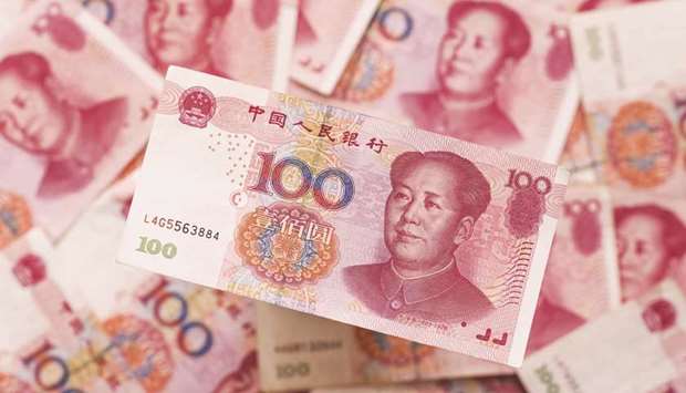 Chinese one-hundred yuan banknotes are displayed in Hong Kong. For China, a possible weaker dollar will lead to a stronger yuan, pressuring officials to halt its appreciation as the economy slows.