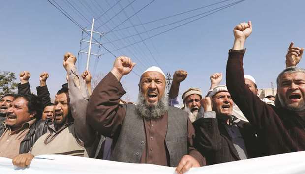 People raise their hands as they chant slogans in solidarity with Pakistan army in Peshawar yesterday.