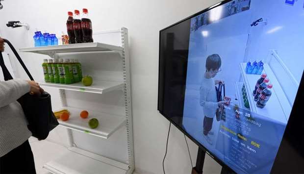 A screen displays a Vaak employee handling a product in a mock store while demonstrating the company's shoplifting-detection system in Tokyo. Vaak, a Japanese startup, has developed artificial intelligence software that hunts for potential shoplifters, using footage from security cameras for fidgeting, restlessness and other potentially suspicious body language.