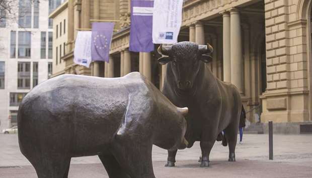 Statues depicting a bear and a bull are seen at the entrance to the Frankfurt Stock Exchange. The DAX 30 index closed 0.6% down at 11,517.80 points yesterday.