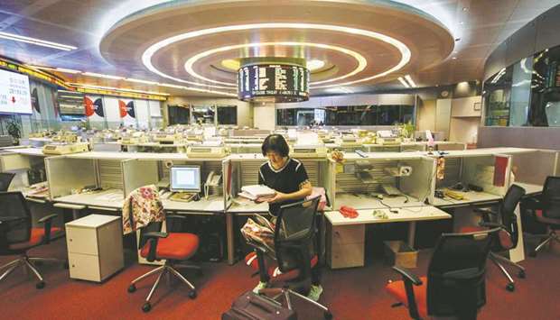 A trader is seen at the Hong Kong Stock Exchange. The index sank 0.9% to 28,779.45 points yesterday.