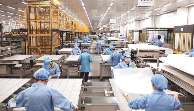 Employees work on photovoltaic solar panels at a factory of Risen Energy in Ningbo, Zhejiang province. Chinau2019s plans to loosen its solar subsidy policy will keep growth of the worldu2019s largest market intact, according to the head of JinkoSolar Holding Co, which is increasing production capacity by as much as 20% this year.