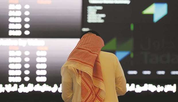 A Saudi investor monitors stock prices at the Saudi Stock Exchange, or Tadawul, in the capital Riyadh (file). The Tadawul Banks Index fell the most in more than two months yesterday. Al Rajhi, the biggest Islamic lender, sank to its lowest level in over a month, while National Commercial Bank dropped 1.7%.