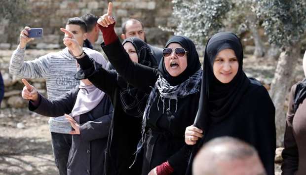 Palestinian women shout slogans, after a group of religious Jews escorted by Israeli security forces entered the premises of the Golden Gate, also known as the Gate of Mercy, inside the Al-Aqsa mosques compound in the Old City of Jerusalem