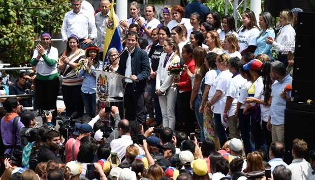 Venezuelan opposition leader and self-declared acting president Juan Guaido (C)speaks during a rally on the International Women's Day in Caracas yesterday.