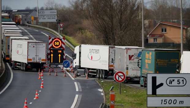 Trucks queue on the Dunkirk-Calais motorway as French Customs Officers increase their controls on transported goods to protest the lack of resources as the Brexit date approaches, in Saint-Folquin, France