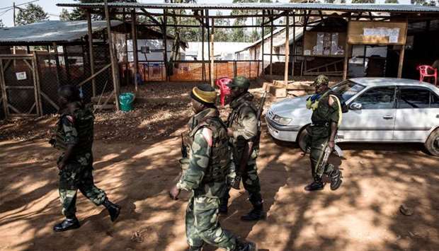 Soldiers from the Armed Forces of the Democratic Republic of the Congo (FARDC) walk outside an Ebola Treatment Centre (ETC) in Butembo, the epicentre of DR Congo's latest Ebola outbreak, after it was attacked