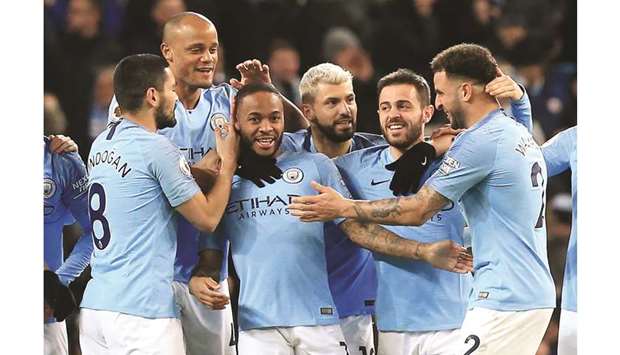 Manchester Cityu2019s midfielder Raheem Sterling (centre) celebrates scoring his first goal with teammates during the English Premier League match against Watford in Manchester yesterday. (AFP)