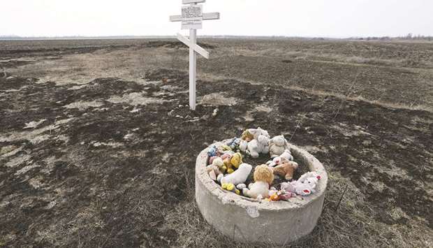 Toys are placed near the cross in memory of victims of Malaysia Airlines flight MH17 plane crash in the village of Rozsypne in Ukraineu2019s Donetsk region.