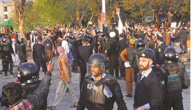 This picture taken on Sunday shows police officers gathering to stop the men from various religious groups from confronting participants of the Aurat March in Islamabad.