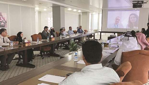 Workers in the refrigeration and air-conditioning sector in Qatar attending a meeting organised by the Ministry of Municipality and Environment via Skype.