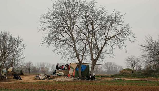 Migrants rest near Turkey's Pazarkule border in Edirne