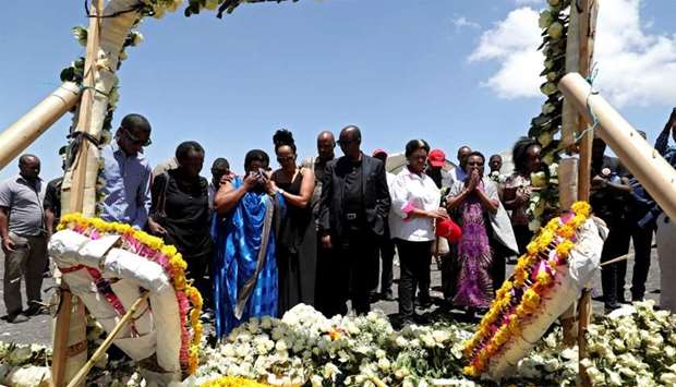 FILE PHOTO: United Nations workers mourn their colleagues during a commemoration ceremony for the victims at the scene of the Ethiopian Airlines Flight ET 302 plane crash