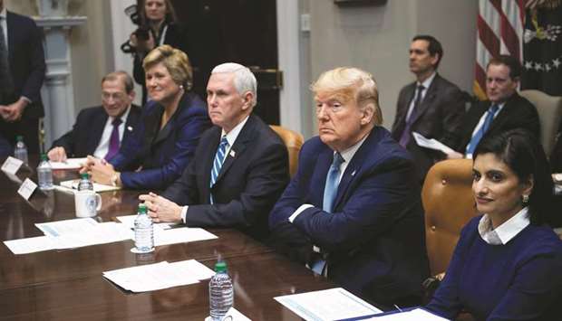 President Donald Trump and Vice President Mike Pence attend a meeting with members of the insurance industry in the Roosevelt Room of the White House yesterday.