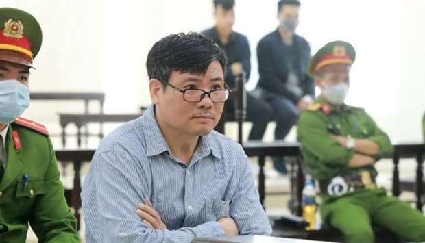 Vietnamese blogger Truong Duy Nhat sitting in a courtroom