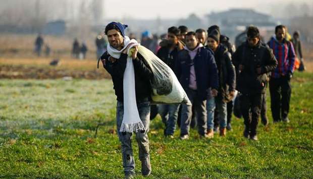 Migrants walk towards the Turkey's Pazarkule border crossing with Greece's Kastanies, near Edirne, Turkey