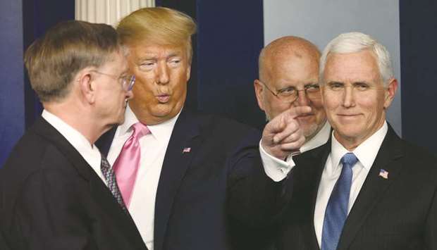 Trump gestures, flanked by Vice-President Pence, after speaking at a news conference on the Covid-19 outbreak at the White House last week.