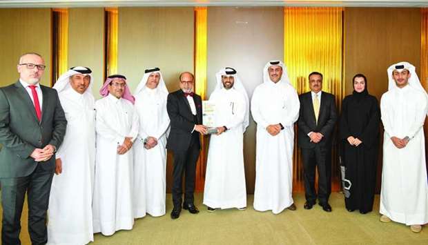 Doha Bank CEO Dr R Seetharaman and QDB CEO Abdulaziz bin Nasser al-Khalifa with the u2018Best Partner Banku2019 award for exposure growth under the Al Dhameen Programme.