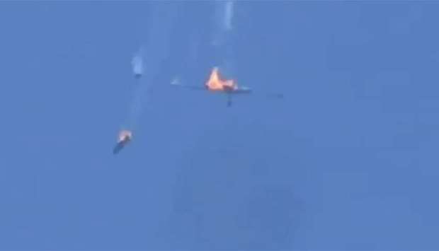 A screenshot from a video being shared on social media that purportedly shows the Syrian government plane falling from the sky after being hit and caught fire